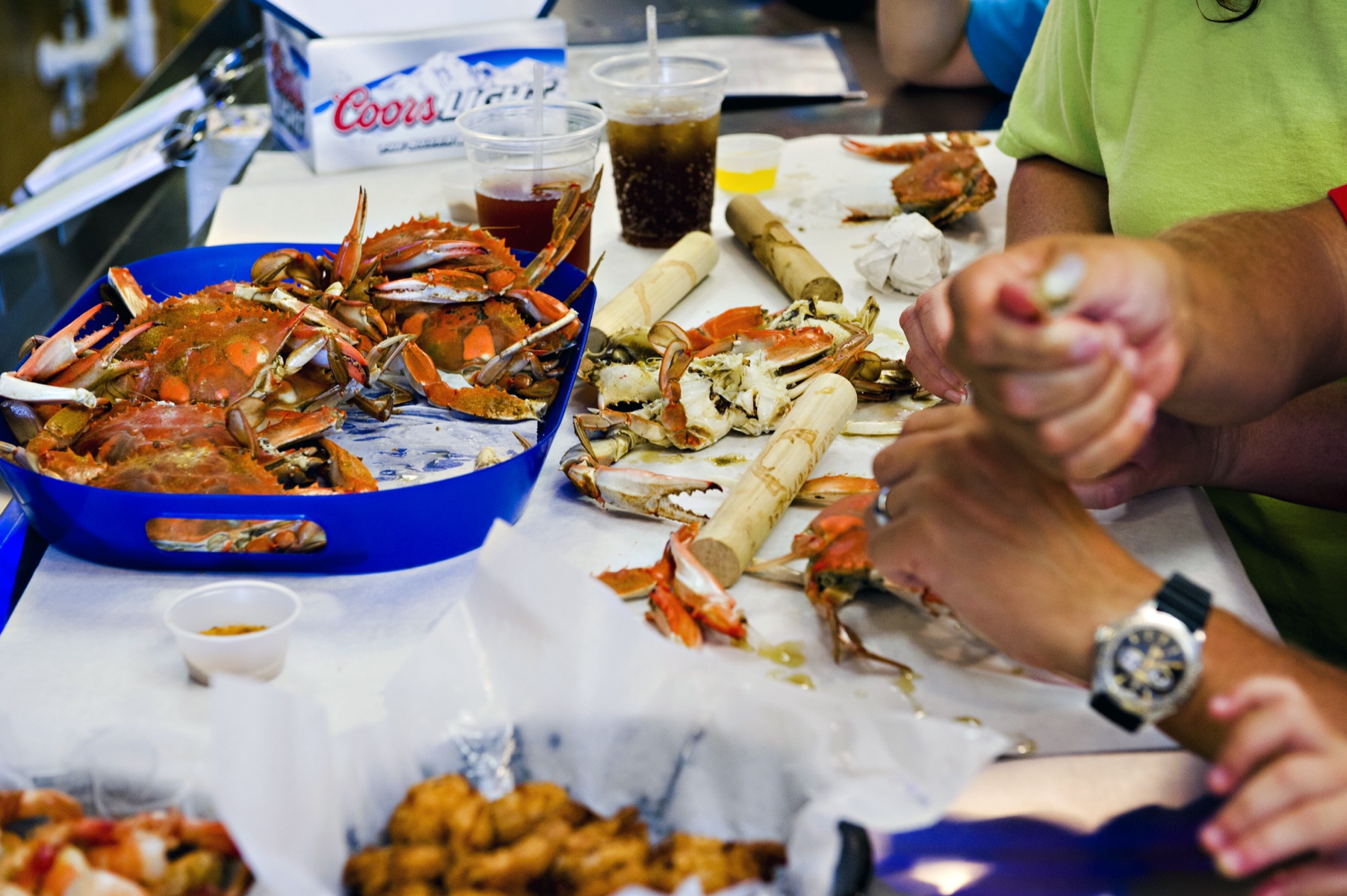 Guests sharing steamed blue crabs with fries at the restaurant
