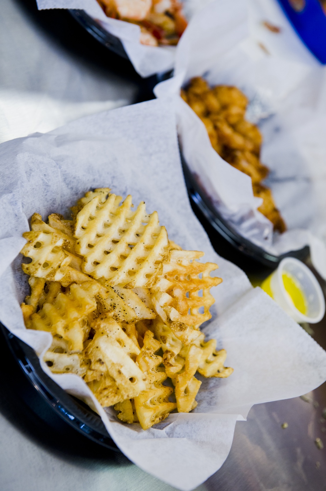 A basket of seasoned waffle fries